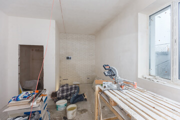 Repair in the house. Wooden table for repair, plastering and painting the walls in the room