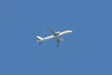Airplane flying in the sky. Commercial passenger jet airliner in flight after take off from the...