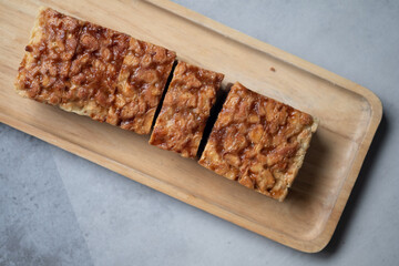 The square slice of toffee cake with cashew nut