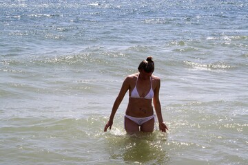 young woman walking on the beach