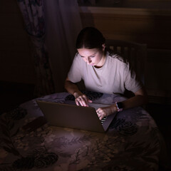 Fototapeta na wymiar Woman freelancer working on laptop late at night at home, sharing social media. Distance job