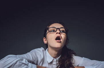 Depression at work. Fatigue. Girl with glasses working from home. Tired look