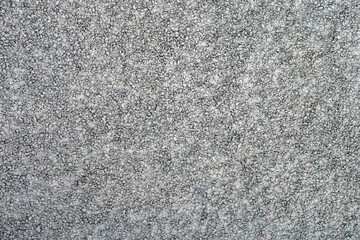 The texture of the plastered wall with a fine gravel of gray color.