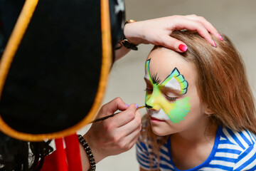 The animator paints the face of the child
