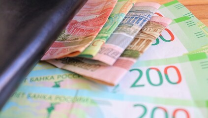 Russian money with a black wallet on the table close-up
