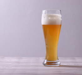 wheat brewed malt beer with foam in a glass