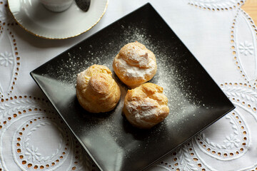 Profiteroles on dark plate