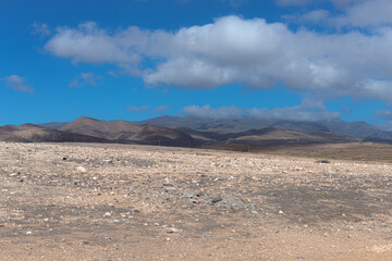 desert landscape of the canary islands with beautiful mountains and a rather attractive sky with some clouds