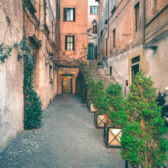 Fototapeta na wymiar View of old cozy street in Rome, Italy. Architecture and landmark of Rome. Postcard of Rome