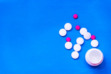 white tablets on blue background. top view