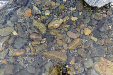 Fototapeta na wymiar The pebbly river bottom.
