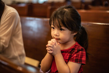 Asian little girl hand praying for faith, spirituality and religion.