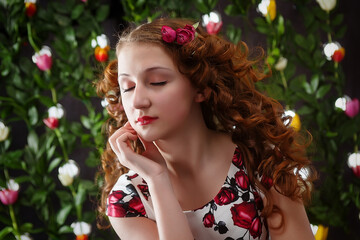 Portrait of a cute girl on a floral spring background. Stylish photography in vintage style.