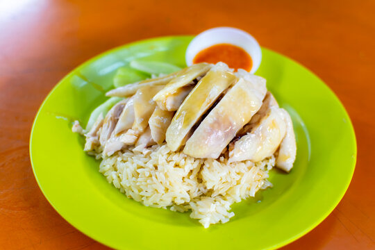 Medium portion of Singapore style Hainanese Chicken Rice served on plastic plate in Maxwell Food Centre