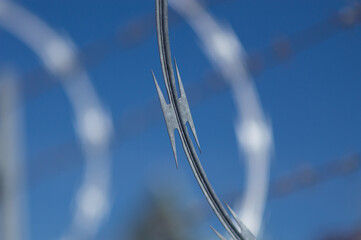 Razor concertina wire against blue sky