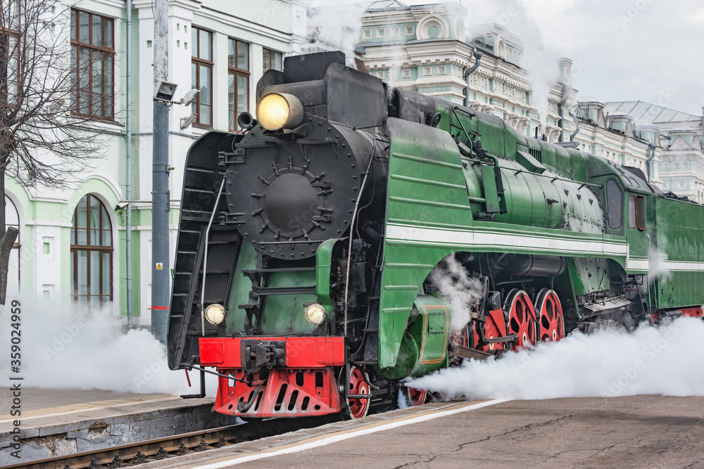 Wall mural Steam train departs from railway station. Moscow. Russia.