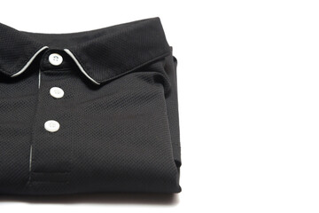 Naklejka premium Folded blank black polo shirt with three white buttons. Polo shirt isolated on white background. Men's clothing.Folded clothes.