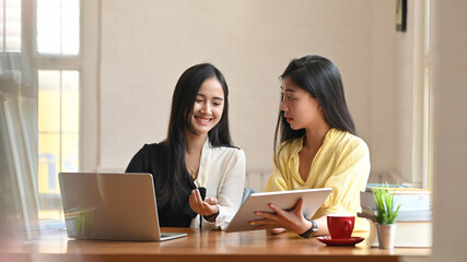 Businesspeople is working together at the wooden table.