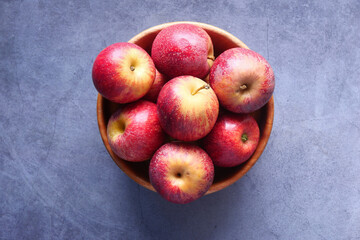 Close up of fresh apple in a bowl on wooden table 