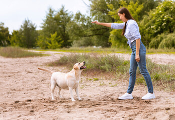 Woman giving a command to her obedient dog