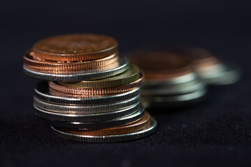 Thai coins, Multiple stacks of Thai coins on black ground
