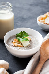 Bowl of homemade cream of mushroom soup with croutons.