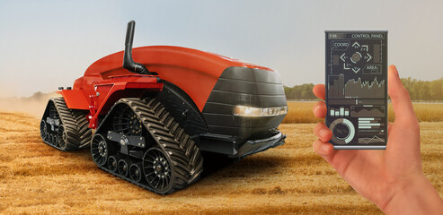 A farmer controls an autonomous tractor through a smartphone mobile application