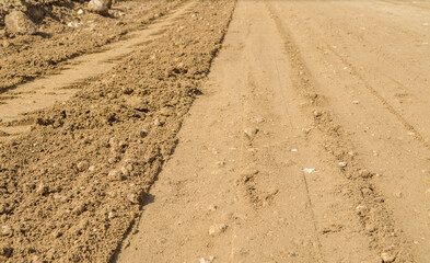 Compacted laterite road.Compact red earth.Compact soil in road construction site.