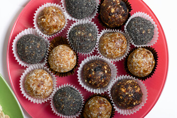 Dried fruit sweets. Balls of prunes, dates and coconut. With a sprinkle of black sesame powder.