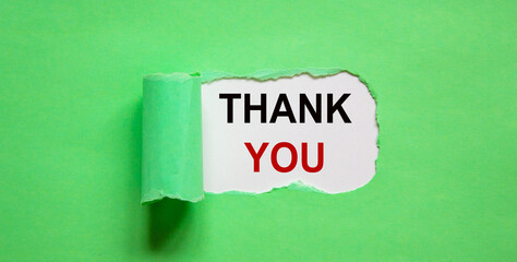 The text 'thank you' appearing behind torn green paper. Beautiful background, copy space.
