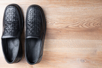 New black men shoes on wooden background. Elastic sided shoes. Side gusset shoes. Lazyman shoes. Top view. Copy space