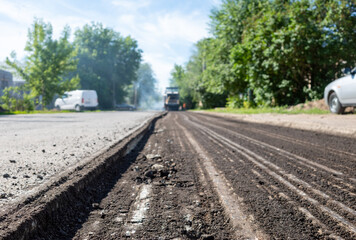 Fototapeta na wymiar Road repair. Replacing the roadway. Change old asphalt road.