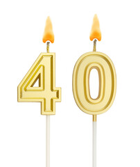 Burning golden birthday candles isolated on white background, number 40	