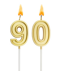 Burning golden birthday candles isolated on white background, number 90