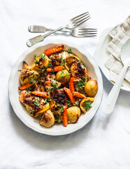 French style creamy chicken and potato bake on a light background, top view. Delicious lunch