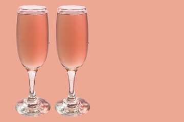 Red wine in glass. Isolated on pink background