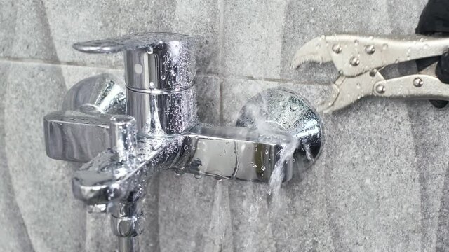 Plumber Fix a leaking tap Faucet by Adjustable wrench , DIY job housekeep  fixing  repair leak in Bathroom