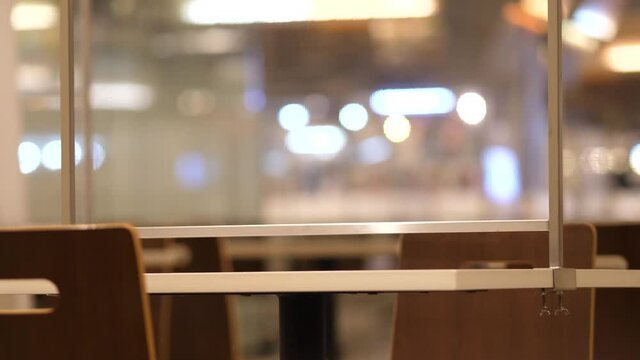 restaurant with table shield to protect infection from coronavirus covid-19, canteen partition and social distancing concept.