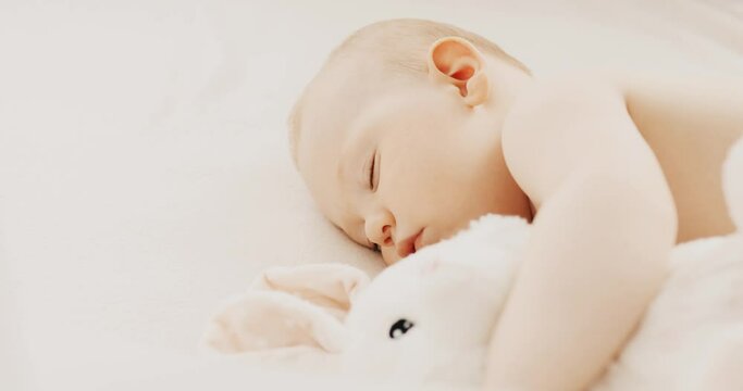 Funny baby sleeping on the bed at home. Children's day lower sleeping position