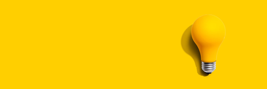 Yellow light bulb - flat lay from above