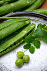 New harvest of ripe green peas legumes