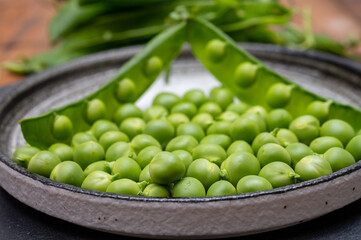 New harvest of ripe green peas legumes