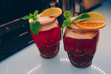ice cold modern Cocktail  gourmet craft white with Sweet caramels decoration slice Author Drink - on bar counter . Close-up Top view . Copy paste space design barman people and luxury nightclub