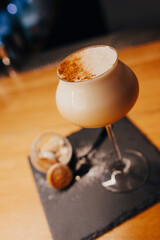 ice cold modern Cocktail  gourmet craft white with Sweet caramels decoration slice Author Drink - on bar counter . Close-up Top view . Copy paste space design barman people and luxury nightclub
