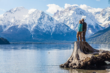 A couple enjoying some spectacular views near Bariloche in Patagonia, Argentina - obrazy, fototapety, plakaty