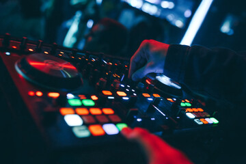 producer  DJ mixer in a nightclub with glowing plays musical rave Dubstep Electronic Trance...