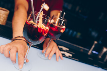 Bartender holding Cocktail near utensil  strainer healthy drink on a bar counter . Professional view . Trendy stylish alcoholic drink .  Design people luxury concept service barman in nightcluba