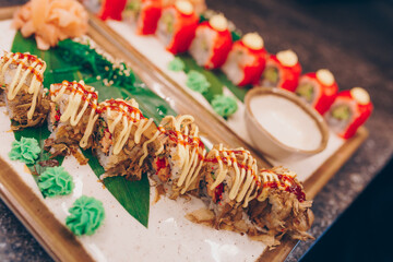 Large set of Sushi Rolls Warm Ebi Sake Unagi Spring. Assortment Philadelphia roll Dishes from Japanese raw fish in one plate in luxury traditional restaurant. Japan food menu service