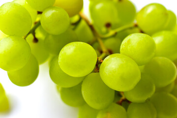 Fototapeta na wymiar Green ripe grapes macrophotography on a white background