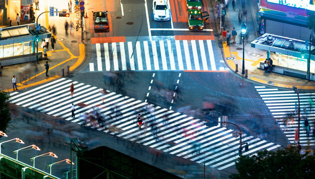 People and traffic cross the famous scramble intersection in Shibuya, Tokyo, Japan, one of the busiest crosswalks in the world